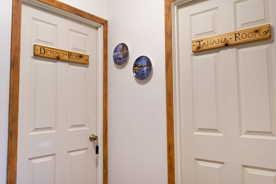 The upstairs hallway with the private bathroom to the right. A floor-length curtain separates this area from the shared stairway, providing privacy.
