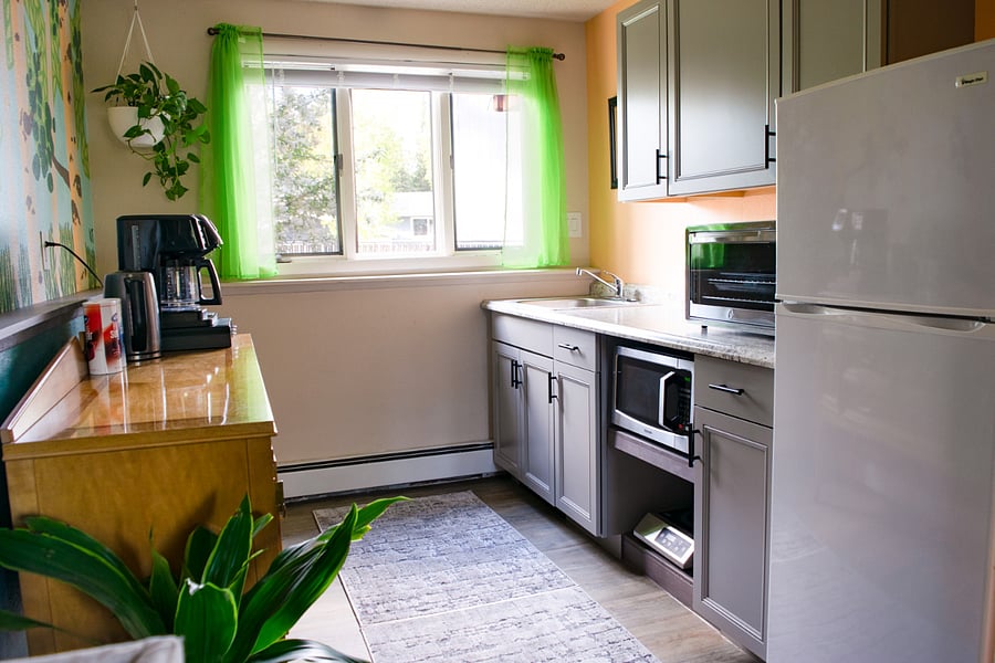 Coffee bar, storage buffet, and kitchenette. Kitchenette has a convection oven/toaster and induction plate in lieu of range. Room-darkening curtains have been added.