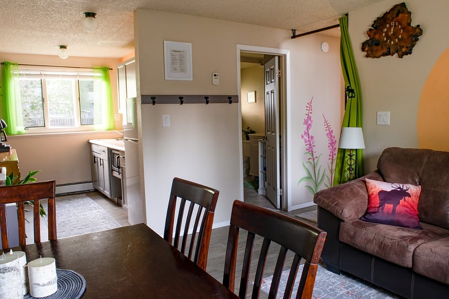 Downstairs with sitting and dining areas, kitchenette, private bathroom, and privacy curtain. Room-darkening curtains have been added.