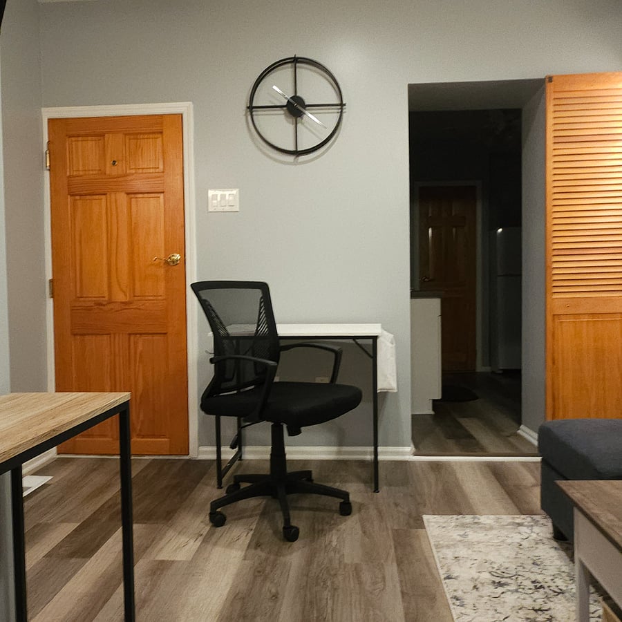 Your compact desk area is located to your left when you first walk in.