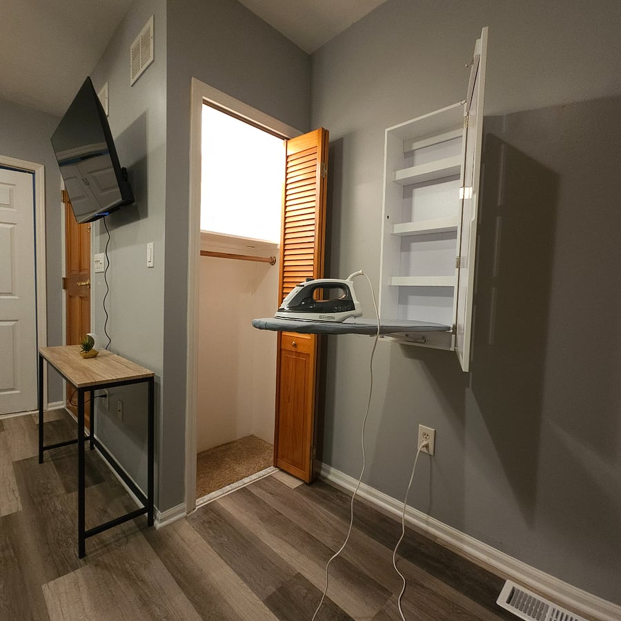 "Closet #1 features an integrated light for convenience, alongside a versatile ironing board and iron, which serve dual purposes, including storage. Perfect for ironing laundry and hanging it directly or pressing jackets efficiently."