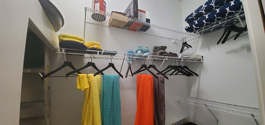 Super spacious walk-in closet stores ALL of your clothes, shoes, plus more! Additional storage and shelving for cleaning supplies, etc., in cubby to your left under water heater.