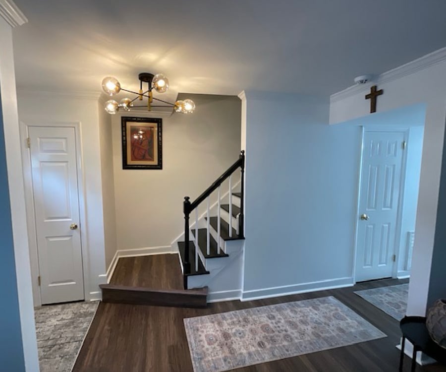 Modern elegance and recently installed luxury vinyl plank flooring throughout & additional storage under the stairs