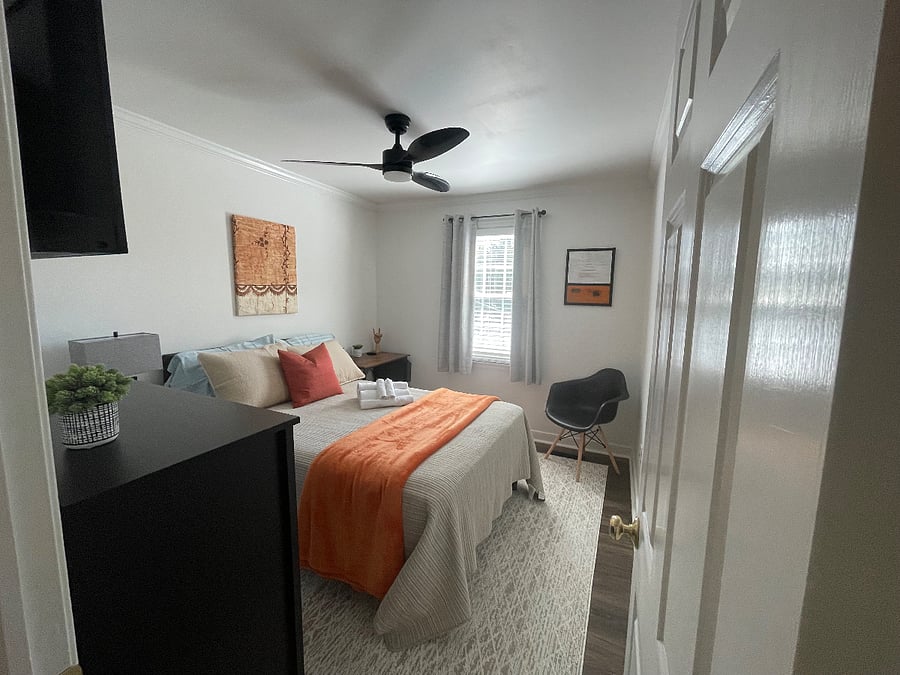 Relax in this serene bedroom with full-sized bed, dedicated workstation, computer monitor, multiple charging ports, full blackout curtains and 40 inch Roku TV for streaming