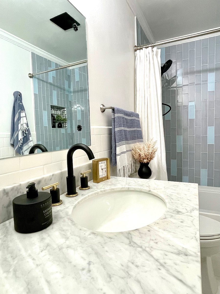 Renovated main bathroom w/new glass tile shower surround, new full-sized bathtub and marble countertop
