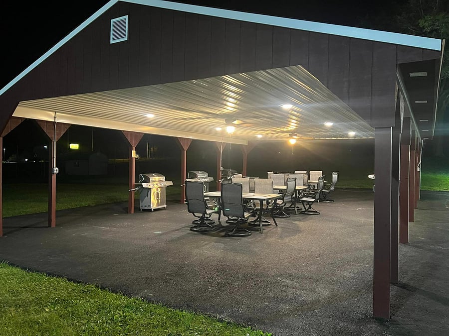 Outside pavilion on the side of the building with grills and tables for tenant use.
