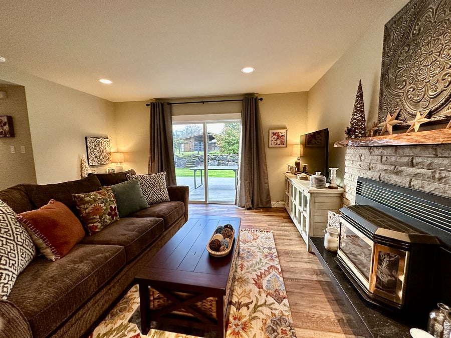 The den is just one of Edgewood Meadows places to hang out, chill, watch your favorite TV show and stay cozy warm in front of the fire! There is large sliding door with access to the back deck, an entry door to the garage and black out curtains for privacy. Youll find a desk with a lamp in the corner for you to work at, as well as a storage closet for extra items.