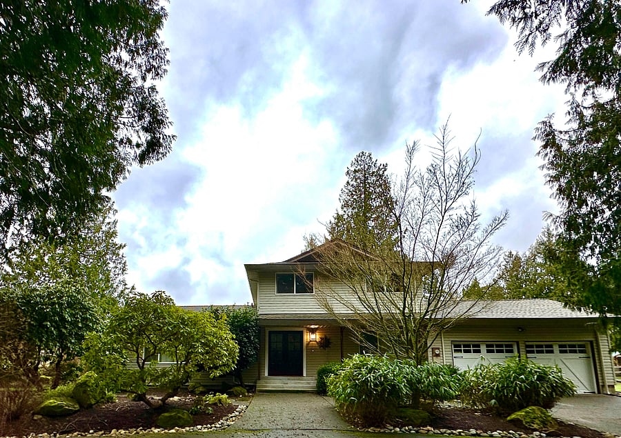 The front side and entrance to Edgewood Meadows. The double parking garage is visible to the right side of the front door of the house! There are plenty of blooming rhododendrons to enjoy during the spring season!