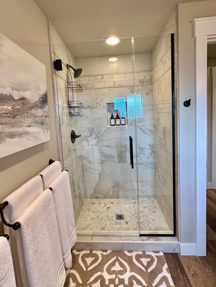 A starter supply of shampoo, conditioner and body wash is included in the large walk-in Italian porcelain tiled shower.