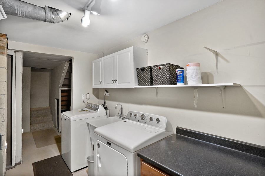 Washer and dryer; cleaning supplies and extra light bulbs located here,