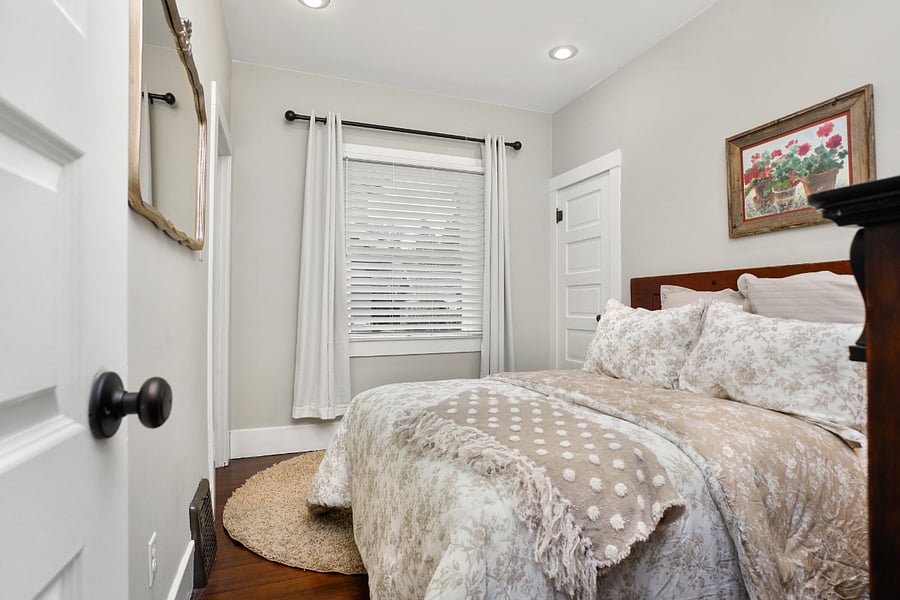 Bedroom 2: Full size bed, dresser, side table and 1 window with black out curtains.
