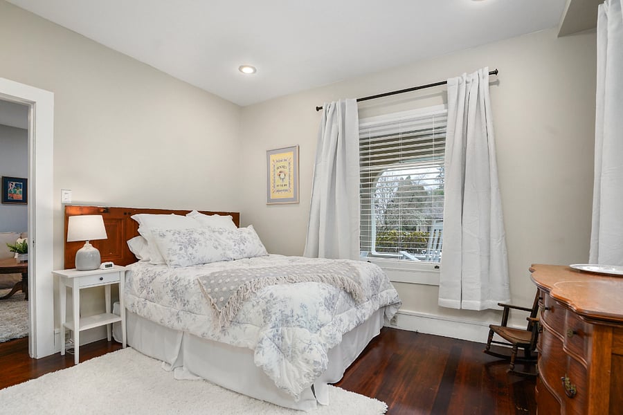 Bedroom 1: Queen size bed, dresser, side table.