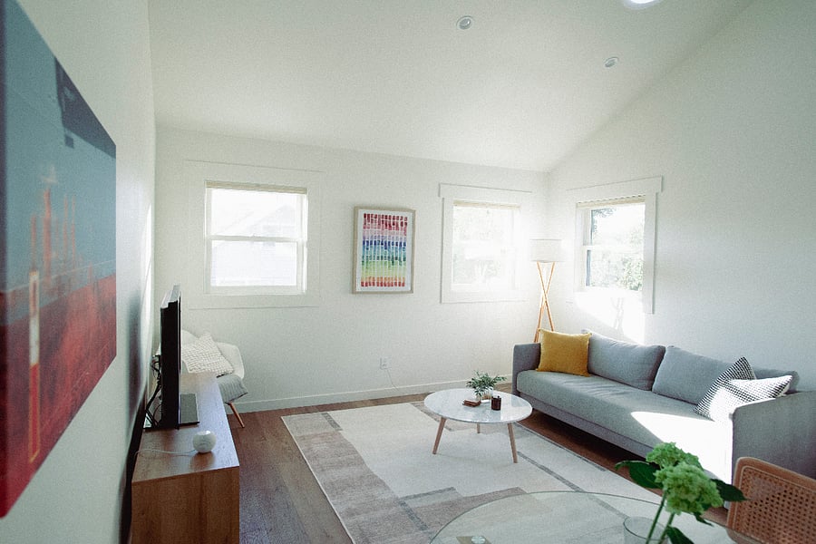 Spacious living room with vaulted ceiling and sky lights
