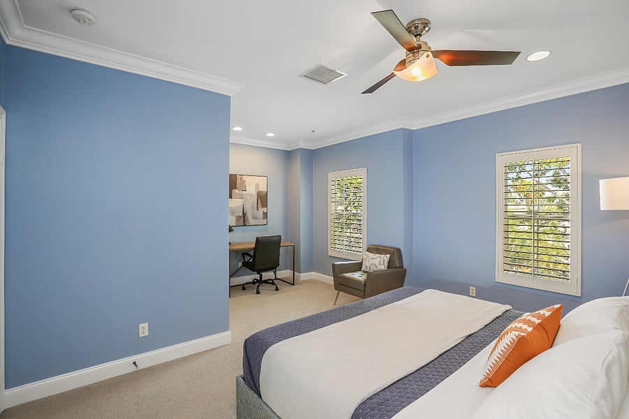 Spacious primary bedroom with room for additional seating and work desk.