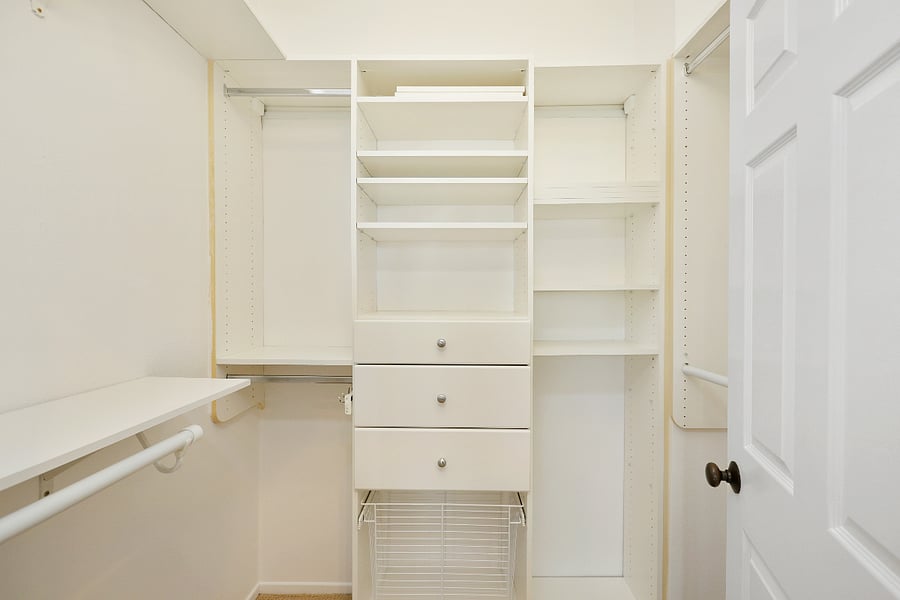 Primary bedroom has a walk-in closet with custom closet organizers.