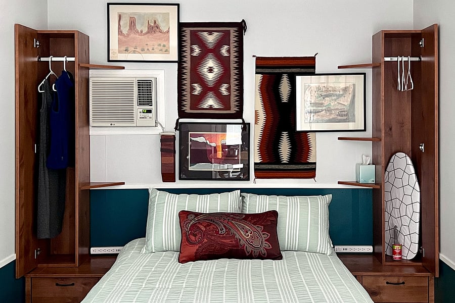 Custom-designed and built wardrobes marry utility and elegance. Wall-mounted power strips on each side of the bed put both standard and USB outlets close at hand.