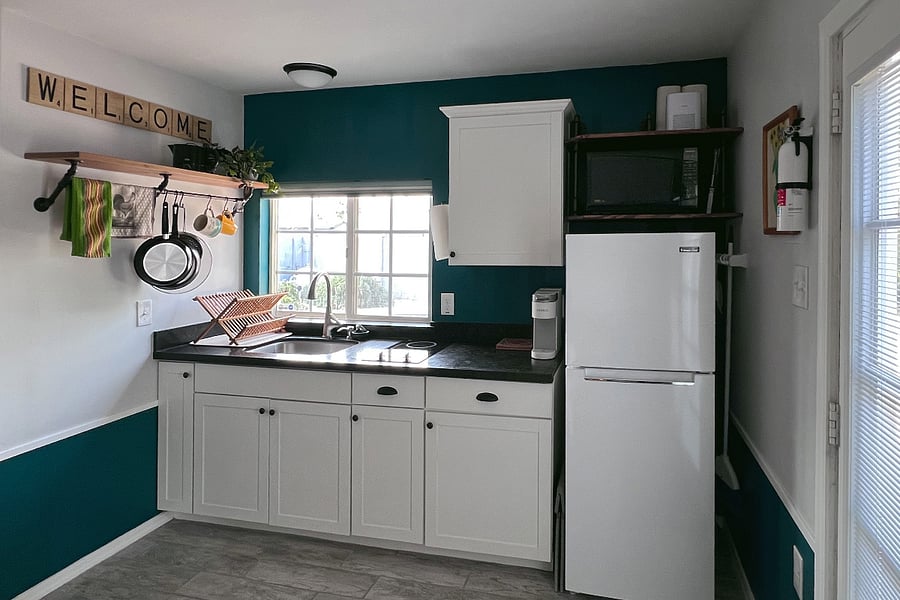 Kitchenette includes fridge & freezer (11 cubic feet), two burner cooktop, and microwave.