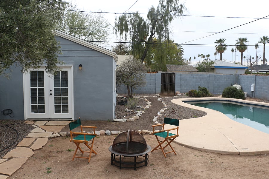 The spacious shared yard includes a pool, portable fire pit, and small patio dining space.