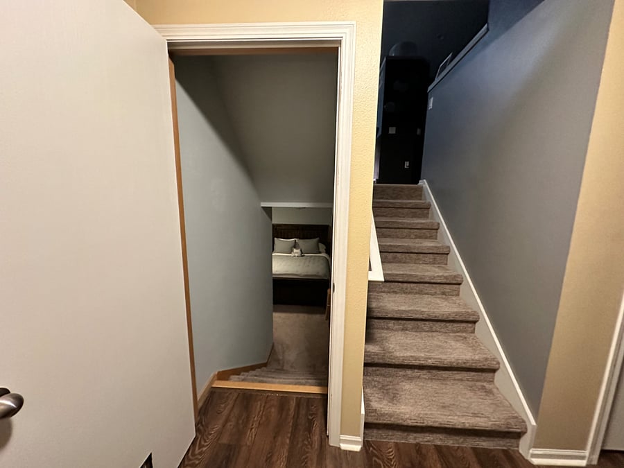 A view of the tenants bedroom privately at the lower level, as you enter the house on the third level living room area, and take additional stairs up to the second level kitchen.