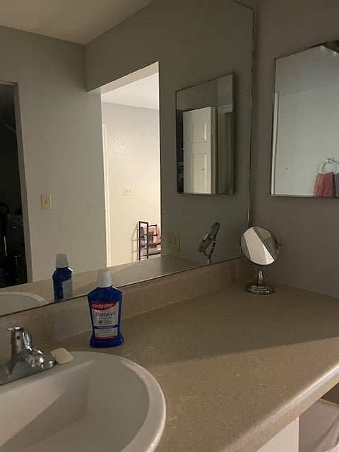 Wide counter in master bath.  Laundry basket under counter.
Also cupboard for cleaning supplies.