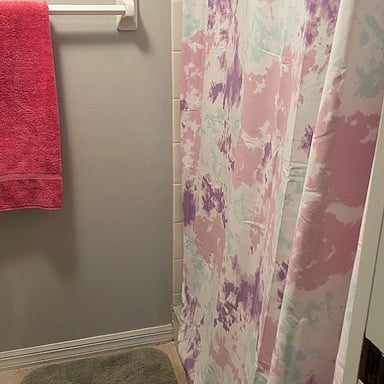 Master bath has walk in shower.  No tub.  Same curtain as visitor's bath.
