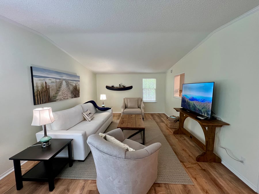 Relax in the living room with plenty of seating and Smart TV.