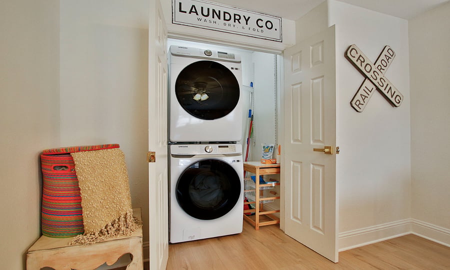 Laundry area with full washer and dryer off of living area.