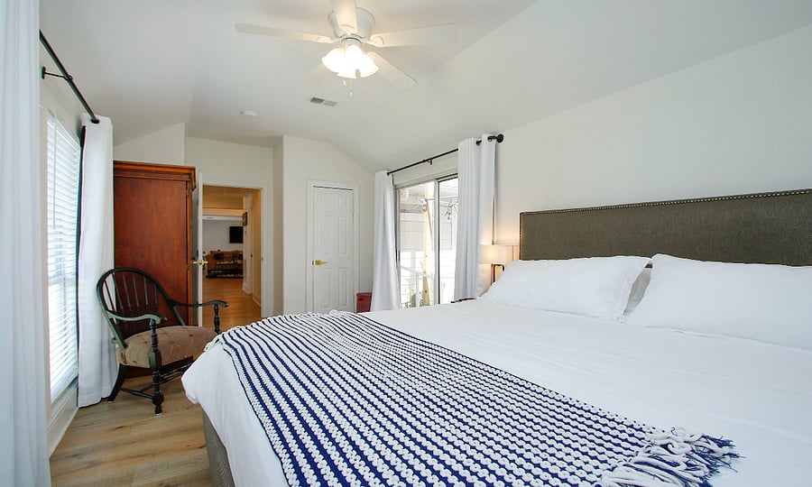 3rd bedroom with King size bed, Smart TV and designated work area.  Armoire opens up to desk for computer and shelves for storage.