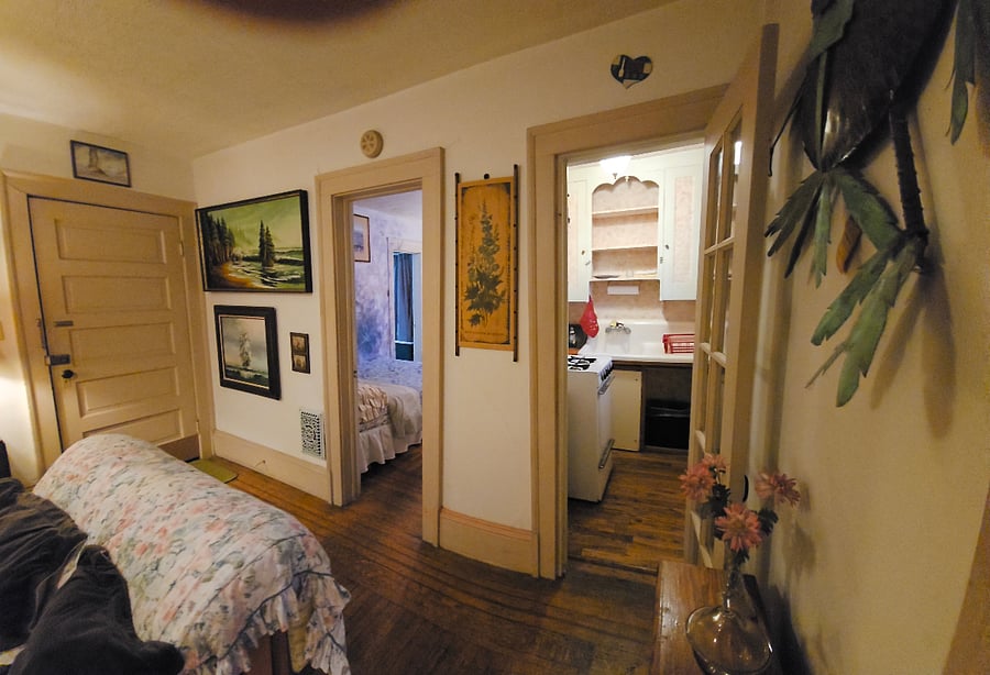 view of bedroom from living room shows entry door from main hallway on second floor landing