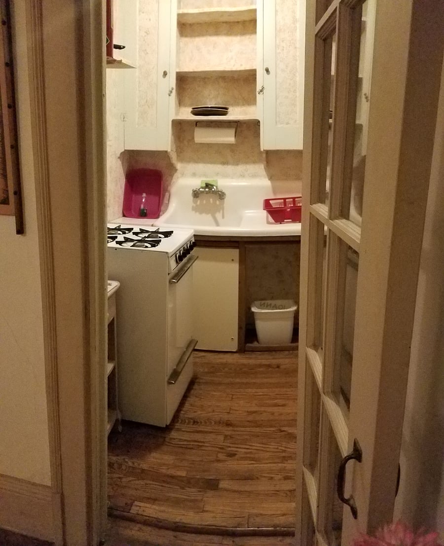 The kitchenette has a gas stove. It was originally a walk-in closet that was retrofitted as a kitchenette after WW1, when the then-owners had grown daughters living at home.
The cast iron sink has been repainted.