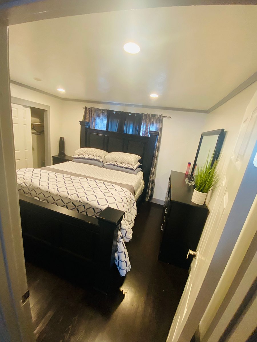 Main bedroom with king size bead and plants of storage 