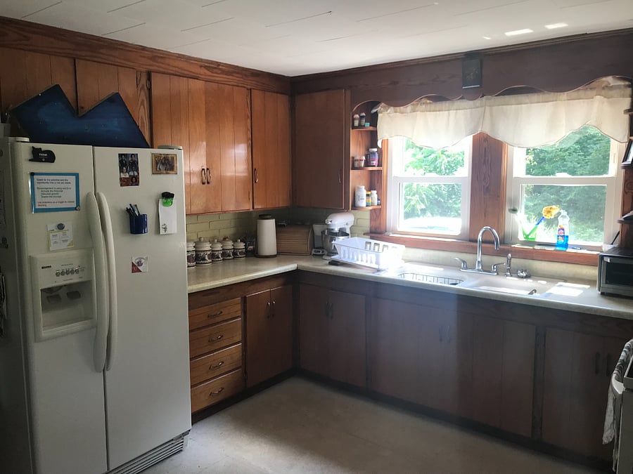Kitchen with electric stove, microwave, airfryer, and George Forman grill, and wok.