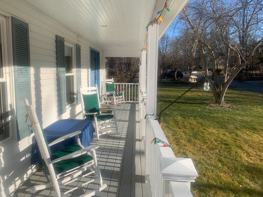 Lovely farmers' porch with birds visiting the feeder.