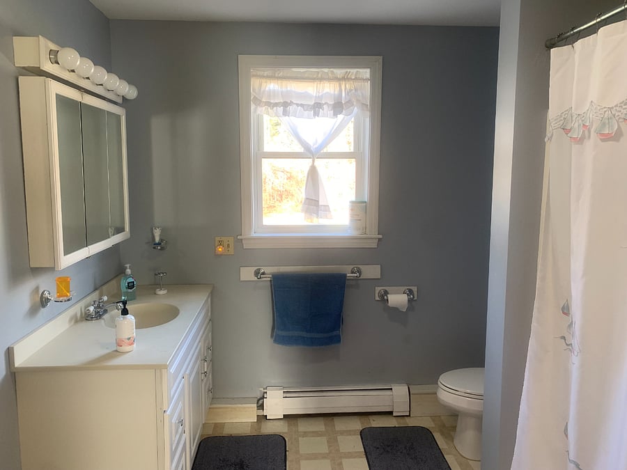 Bathroom across from room with a bathtub and shower.
