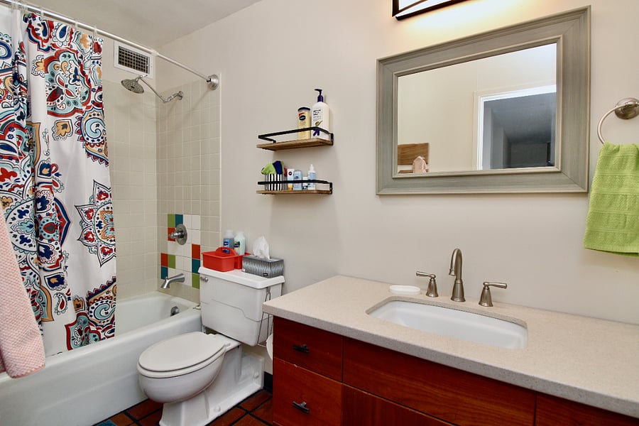 Shower tub combination. Vanity has lots of drawers for storage.