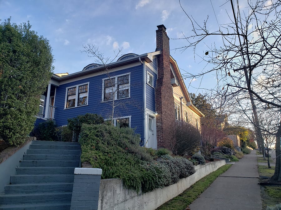 Exterior of house. MIL entry is white door near chimney.