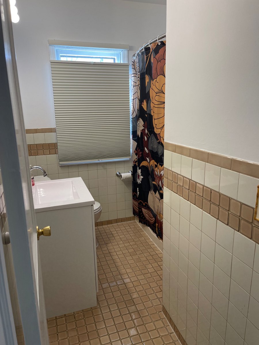 Full Bath - with ceiling fan and light over shower. And a window... sunny!