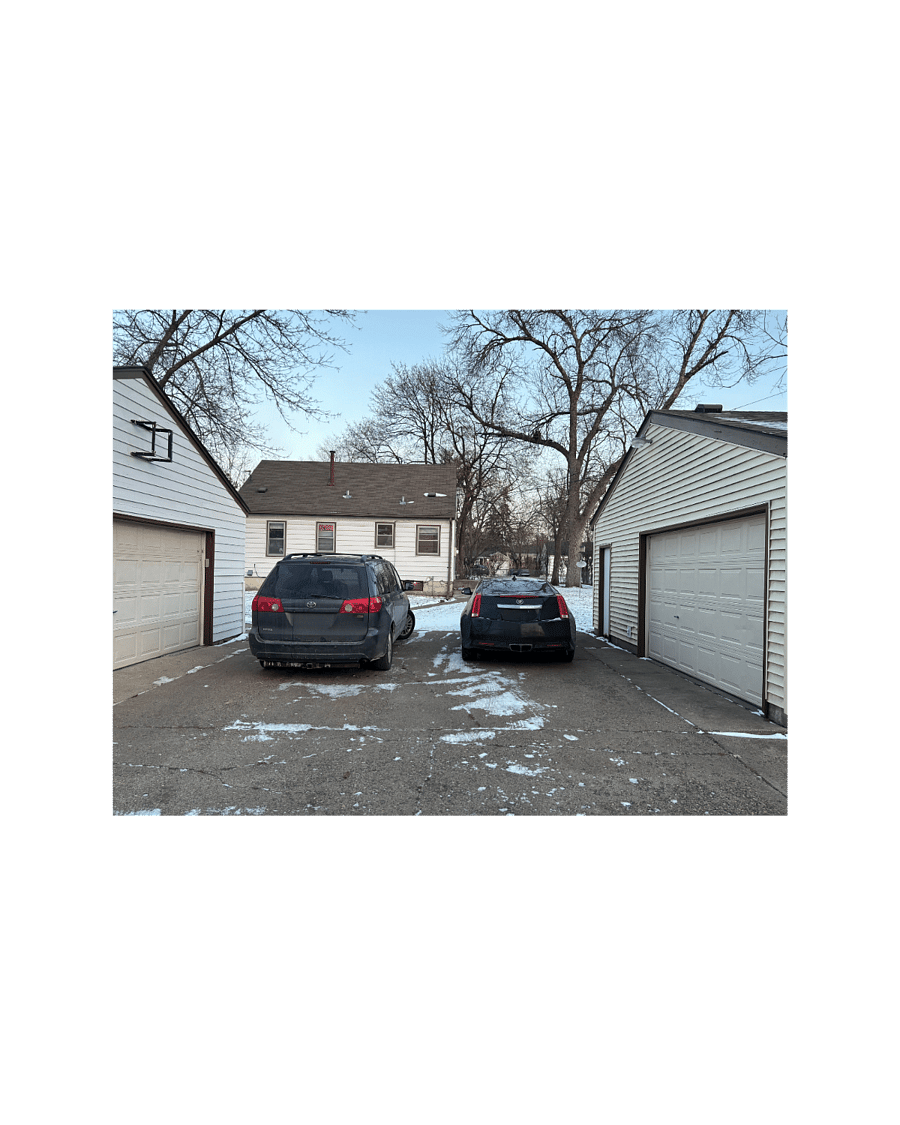 Back view of house from alley. 2 spaces wide in driveway between garages.