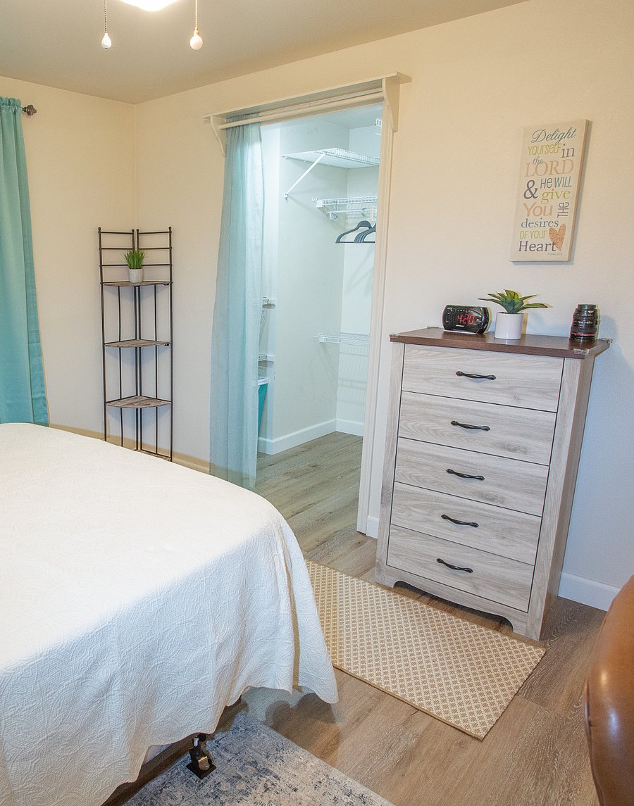 Bedroom has a walk-in closet, dresser and lots of storage options.