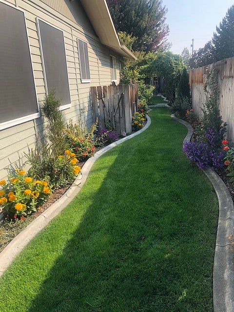 This side yard is down the length of the unit from the front to the back yard. It is gated and not used except for gardening purposes.