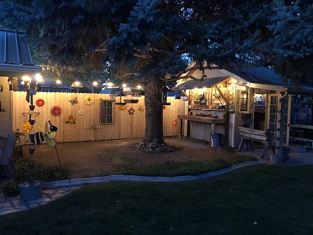 Potting shed and work area awash in lighting at dusk.