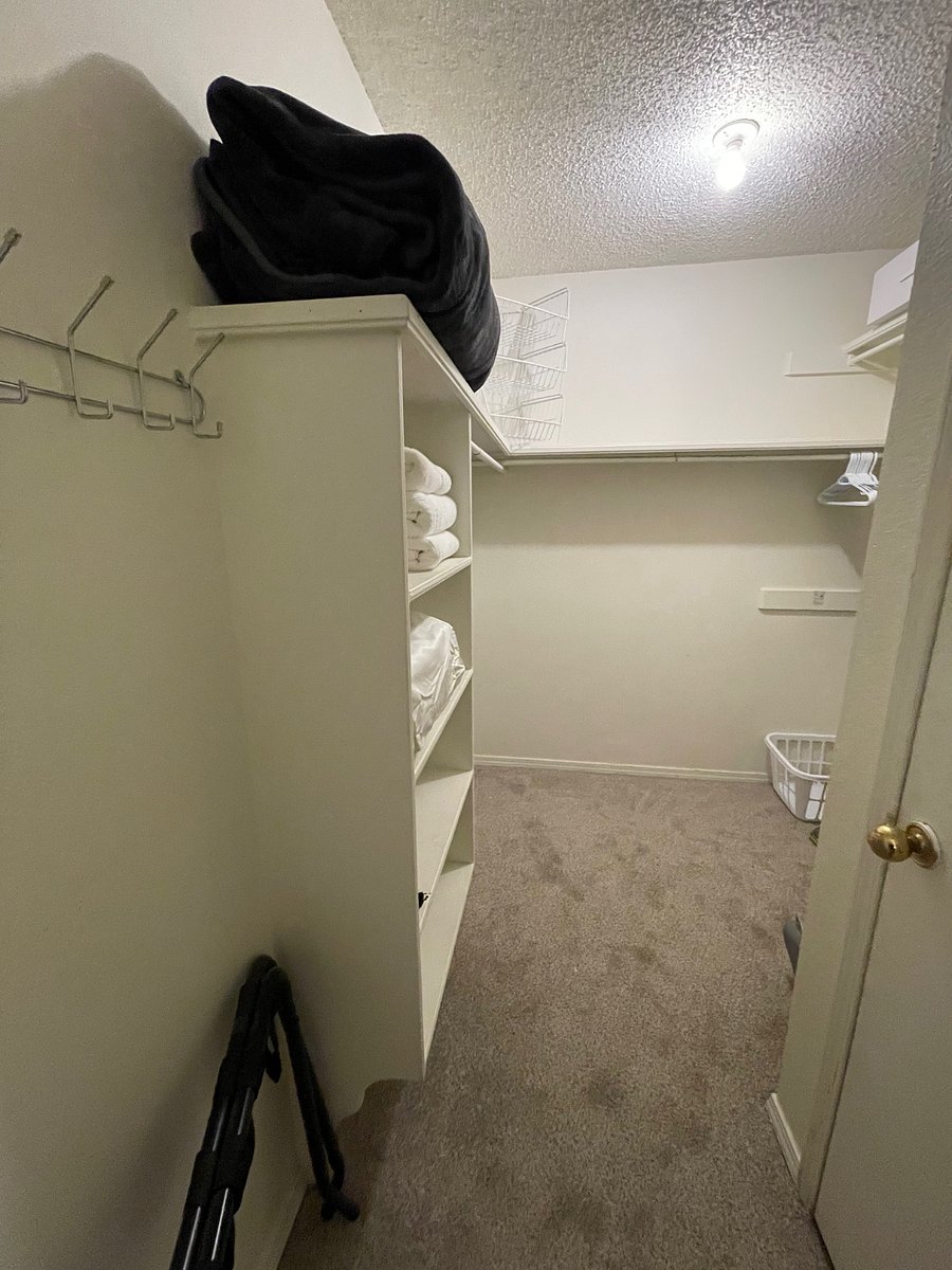 Very large walk-in closet with tons of hanging space and acrylic bins for storage. Laundry hamper, iron and ironing board, and 30 hangers are provided.