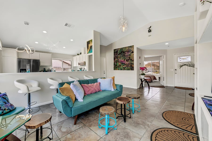 Modern looking couch with high chairs. 