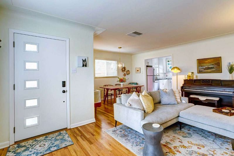 Main floor living room with Smart TV and piano.