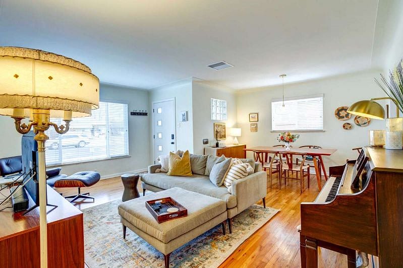 Main floor living room with Smart TV and piano.