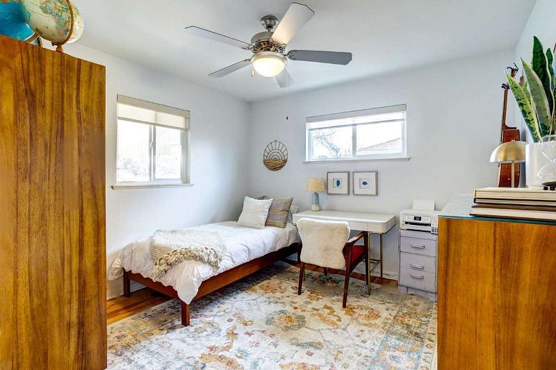 Bedroom on main floor with twin-sized bed and desk