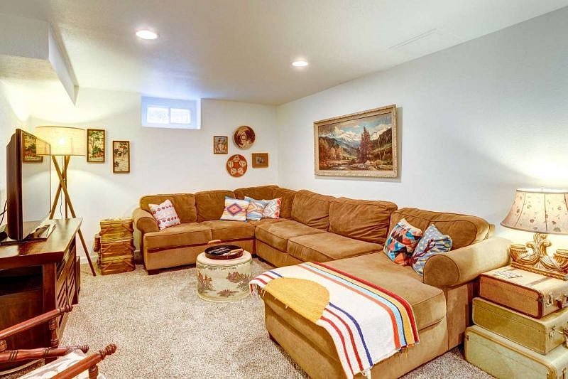 Basement living room with large sofa, Smart TV and desk