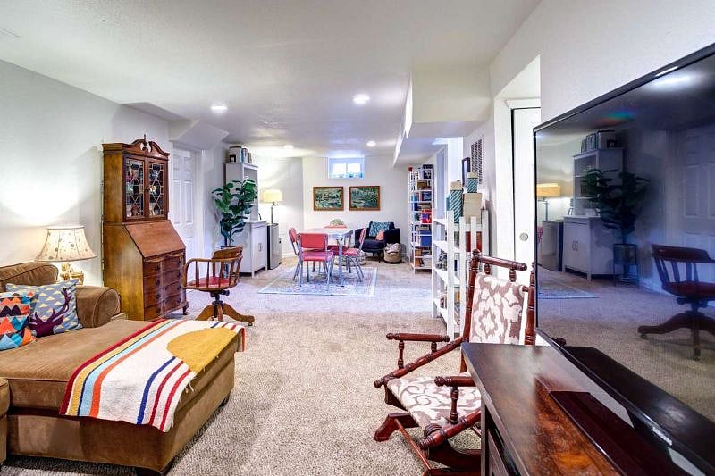 Basement living room with large sofa, Smart TV and desk