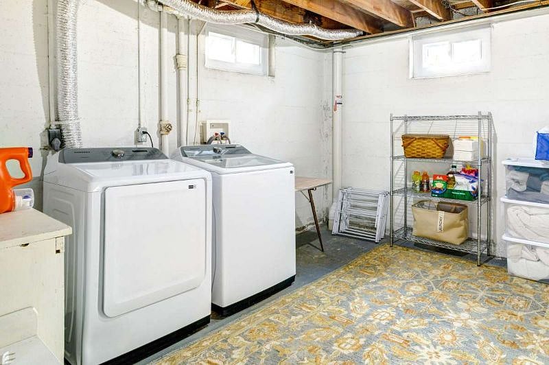 Laundry room in basement with new full-sized washer/dryer