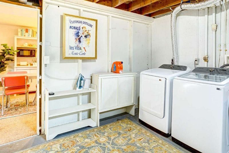 Laundry room in basement with new full-sized washer/dryer